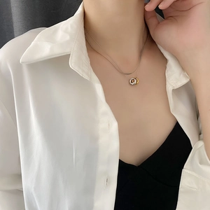 Minimalist tricolor interlocking triple ring pendant necklace on a double snake chain