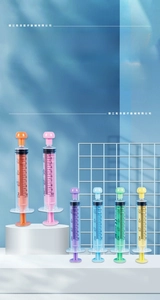 Detail view of 10ml multi-colored syringes with clear dual scales in tsp and ml units