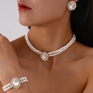 Close-up of elegant double-layer faux pearl jewelry set with sparkling oval crystals