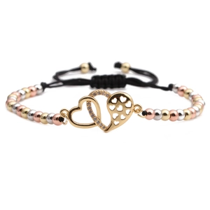Close-up of adjustable woven bracelet with tri-tone beads and interlocking twin hearts