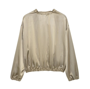 Rear view of cropped satin jacket showing glossy texture and elastic hem and cuffs