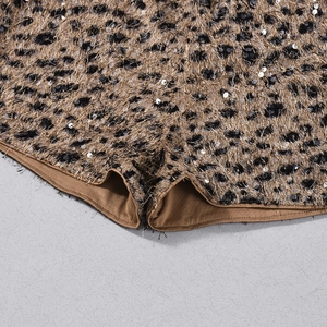 Close-up of leopard print shorts featuring sparkling sequins and soft faux fur texture