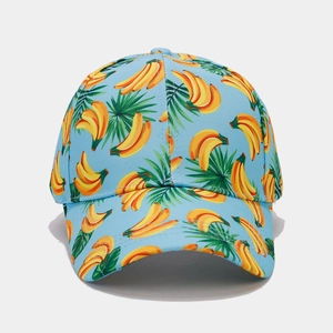 Close-up of tropical banana and palm leaf print on a light blue cotton baseball cap
