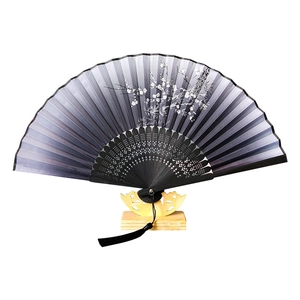 Classic Chinese folding fan with black plum blossom pattern and elegant silk tassel