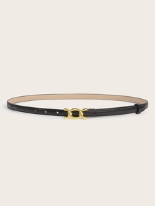 Close-up of slim black leather belt with a polished interlocking gold metal buckle