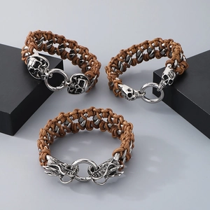 Macro shot of vintage braided leather bracelets with skull and dragon steel buckles