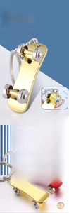 Detail showing 360-degree rotating wheels and double-kick deck of metal scooter keychain