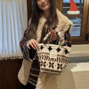 Detail view of winter plush tote bag with ethnic patterns and soft fleece texture