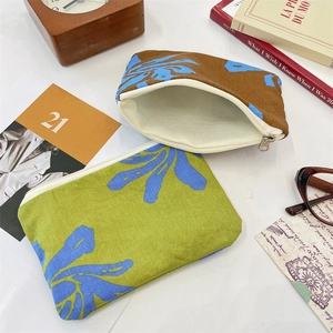 Detail view of floral canvas storage pouches with white zippers and durable metal pulls
