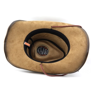 Inside view of brown suede cowboy hat with adjustable chin strap and classic wide brim