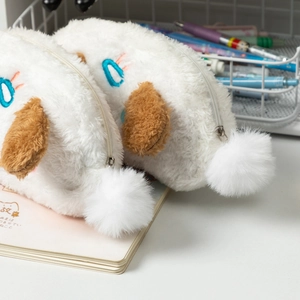 Détail d'une trousse peluche blanche chiot avec oreilles brunes et fermeture à glissière douce