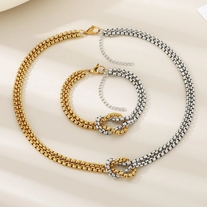 Detail of two-tone gold and silver knotted chain necklace and bracelet set