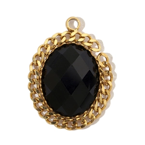 Detail shot of vintage gold-plated oval pendant with black faceted stone and chain border