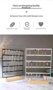 Detail view of 5-tier metal jewelry organizer with natural wood base for earring display