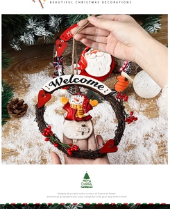 Detail of Christmas wreath featuring a plush snowman and rustic Welcome wooden sign