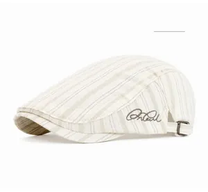 Detail view of British style blue striped flat cap with side brand embroidery and metal strap