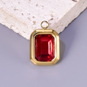 Golden titanium steel rectangular pendant with a faceted red crystal gemstone