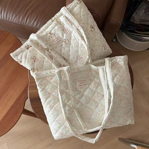 Detailed close-up of quilted cotton tote bags with cute bear and floral prints