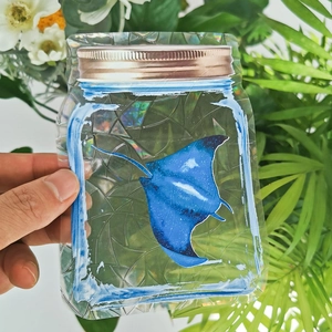 Holographic mason jar window sticker featuring a glowing blue manta ray ray design