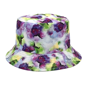 Detail of floral bucket hat featuring vibrant purple, green, and yellow watercolor pattern