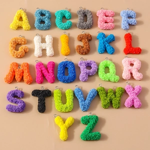 Macro view of 26 colorful resin alphabet charms with detailed 3D rose floral textures