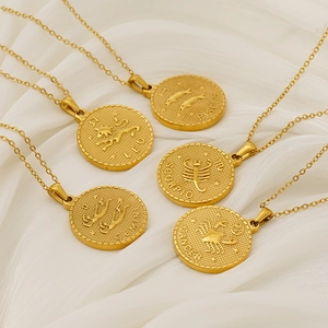 Gold zodiac coin necklaces with 3D relief on white silk, featuring Pisces and Scorpio