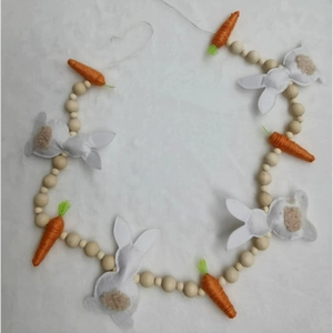 Detail of Easter bunny and carrot garland featuring felt rabbits and wooden beads