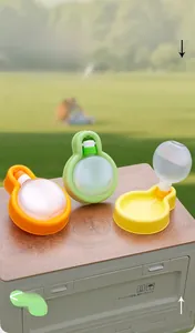 Detail of colorful portable pet water bottles with gravity feed bowl in nature setting