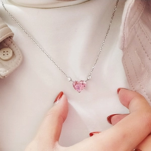 Elegant heart-shaped pink gemstone necklace for women with silver chain shown on neck