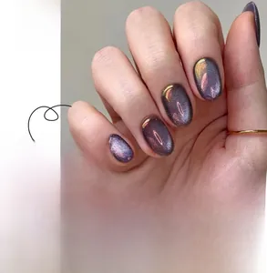 Detailed cat eye press-on nails in purple and gold with aurora chrome metallic finish