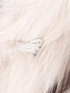 Close-up of premium faux fur texture in light pink showing soft and dense fibers