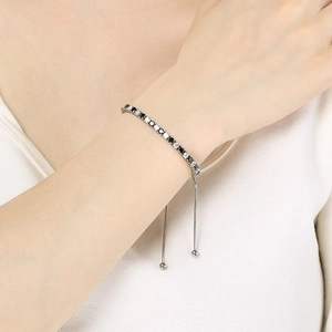 Detail of silver steel bracelet with black and white zircons and adjustable slider