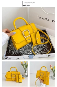 Detail of yellow candy-colored crossbody bag with mini pouch and gold buckle
