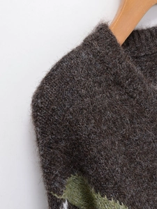 Detail view of plush mohair knit sweater showing soft texture and diamond pattern