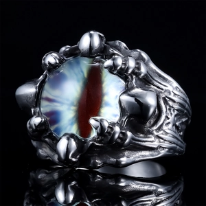 Macro shot of a gothic dragon claw ring featuring a detailed purple evil eye and metal textures