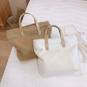 Minimalist woven tote bags in khaki and cream with brown faux leather handles