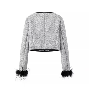 Back view of a grey tweed jacket featuring elegant black feather trim on sleeve cuffs