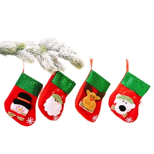 Christmas stockings set with Santa, Reindeer, Snowman, and Polar Bear hanging on pine branch