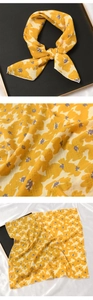 Vue détaillée du foulard en coton et lin avec motif floral jaune et gris