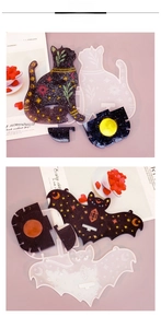 Detail of DIY cat and bat silicone molds with celestial resin moon and star patterns