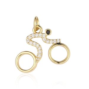 Detailed view of golden bicycle charm with sparkling zircon inlay and black stone accent
