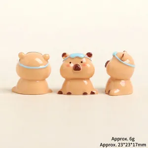 Three-view set of resin capybara figurines with blue headbands and polished finish