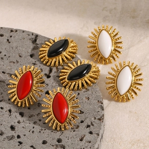Detailed macro shot of vintage-style marquise stud earrings in red, black, and white colors