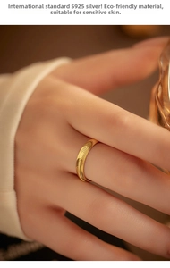 Macro detail of gold S925 sterling silver ring with fingerprint wavy texture on model hand