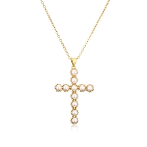 Minimalist gold plated copper necklace with a pearl cross pendant on white background