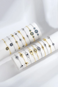 Detailed view of Evil Eye bracelets with blue zircon and enamel on white pedestals