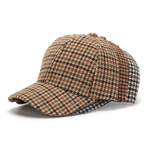 Close-up of stacked houndstooth baseball caps in various colors with detailed fabric texture