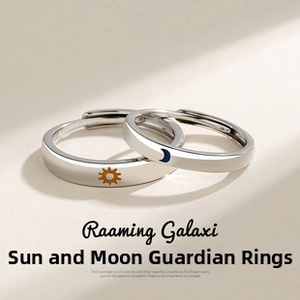Macro shot of S925 sterling silver couple rings showing sun and moon engraved patterns