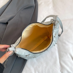 Silver textured large tote bag with bright yellow lining and metal zipper closure