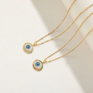 Detail of evil eye pendants with rainbow and white zircons on 14K gold plated chains